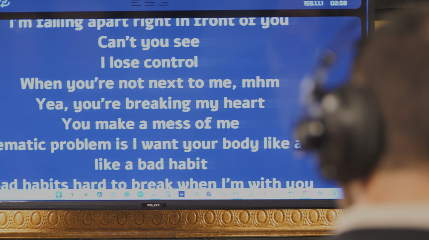 Singer reading scrolling lyrics on a studio teleprompter powered by LyricsRunnerVST